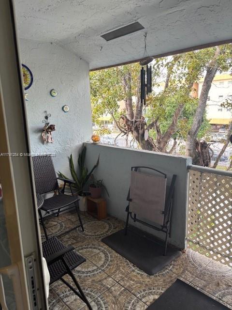 view of patio featuring a balcony