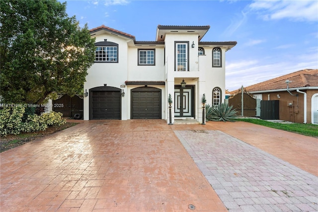 mediterranean / spanish-style house with a garage