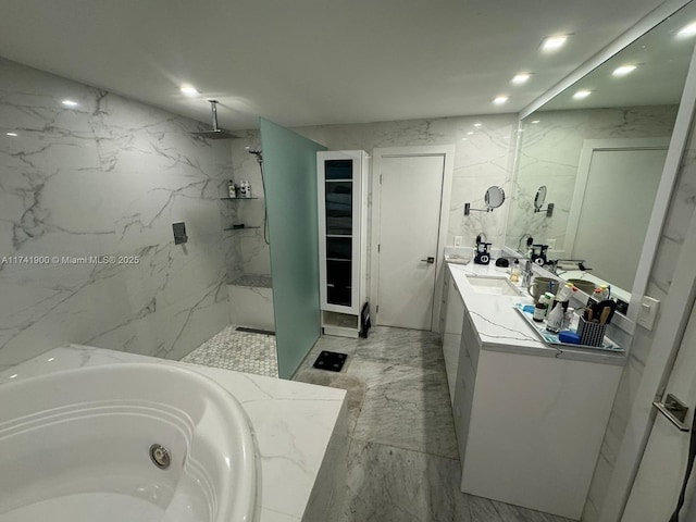 bathroom featuring vanity and shower with separate bathtub