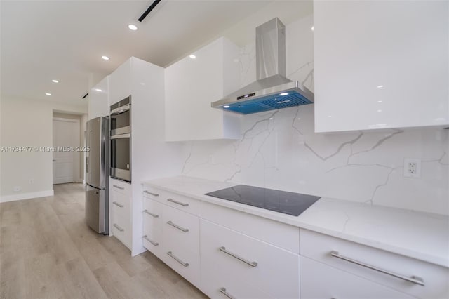 1617 NE 11th St Unit 1, Fort Lauderdale, FL 33304 - kitchen featuring appliances with stainless steel finishes, modern cabinets, island range hood, white cabinetry, and light stone countertops
