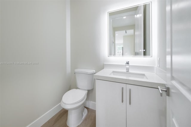 1617 NE 11th St Unit 1, Fort Lauderdale, FL 33304 - bathroom featuring toilet, vanity, baseboards, and wood finished floors