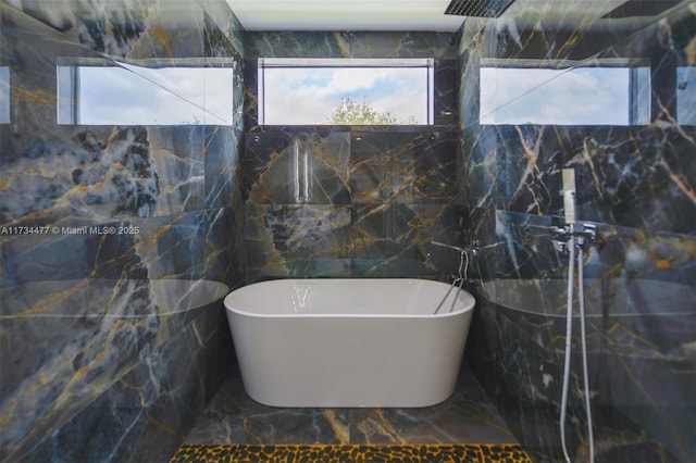 1617 NE 11th St Unit 1, Fort Lauderdale, FL 33304 - full bathroom with marble tiled floors, tile walls, a freestanding tub, and a shower