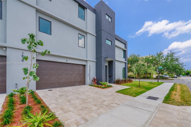 1617 NE 11th St Unit 1, Fort Lauderdale, FL 33304 - contemporary house with decorative driveway, an attached garage, and stucco siding