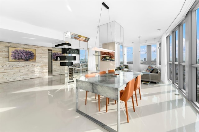 dining room with wine cooler, wooden walls, and expansive windows