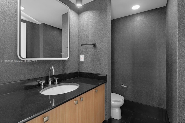 bathroom featuring tile patterned floors, toilet, and vanity