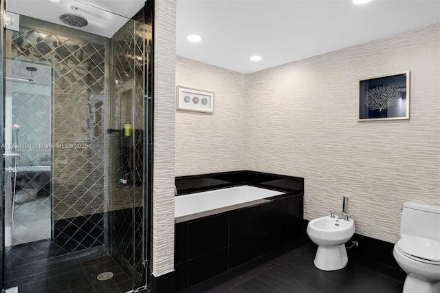 bathroom featuring toilet, tile walls, a bidet, a shower with door, and tile patterned flooring