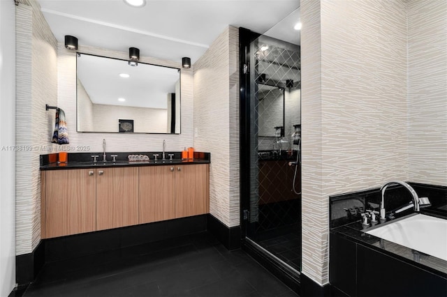 bathroom with vanity, tile patterned flooring, tile walls, and separate shower and tub