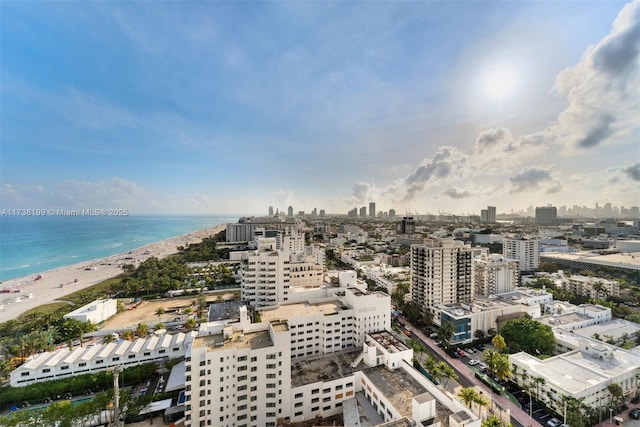 drone / aerial view featuring a beach view and a water view