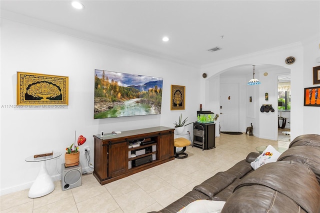 living room with ornamental molding and light tile patterned floors