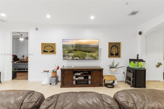 living room featuring ornamental molding and light tile patterned floors