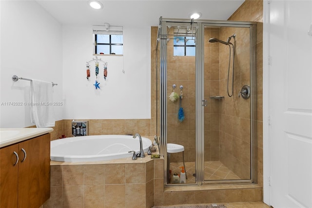 bathroom featuring vanity and separate shower and tub