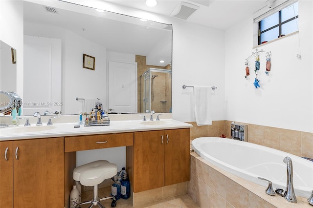 bathroom with tile patterned floors, vanity, and shower with separate bathtub