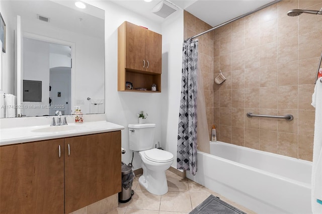 full bathroom with vanity, shower / bath combination with curtain, tile patterned floors, and toilet