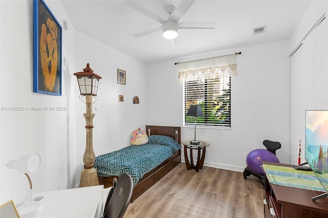 bedroom with ceiling fan and light hardwood / wood-style flooring