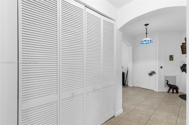 hall with light tile patterned floors