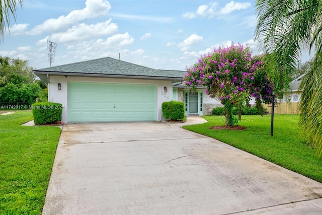 single story home featuring a garage and a front lawn