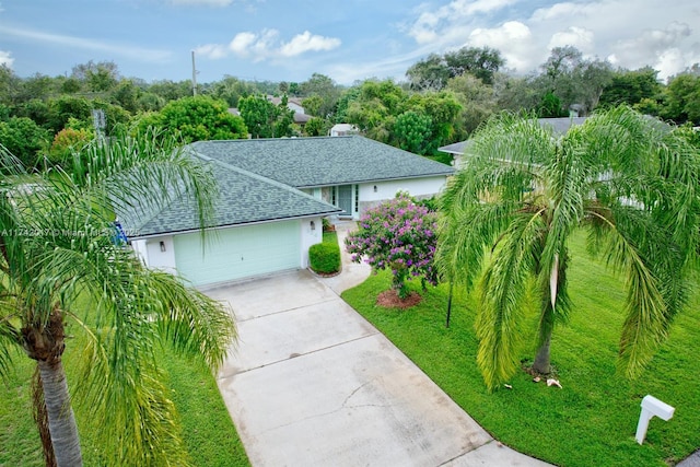 view of front of house featuring a garage and a front lawn