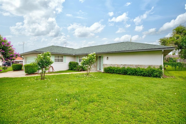 single story home featuring a garage and a front yard