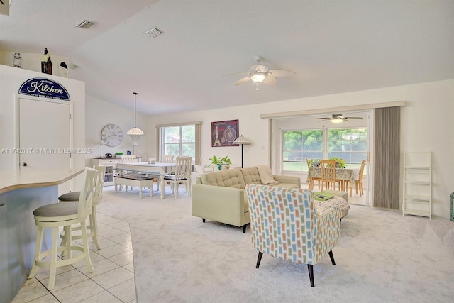 living room featuring vaulted ceiling, light carpet, and ceiling fan