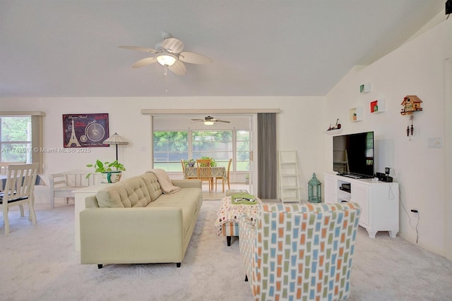 living room featuring vaulted ceiling, light carpet, and ceiling fan