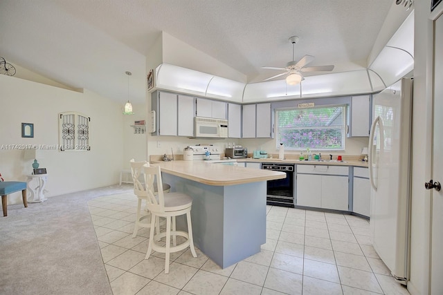 kitchen with vaulted ceiling, white appliances, ceiling fan, kitchen peninsula, and a textured ceiling