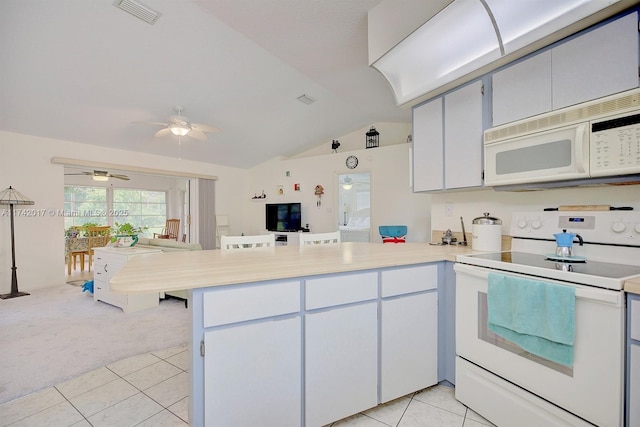 kitchen featuring white cabinetry, light tile patterned floors, white appliances, and kitchen peninsula