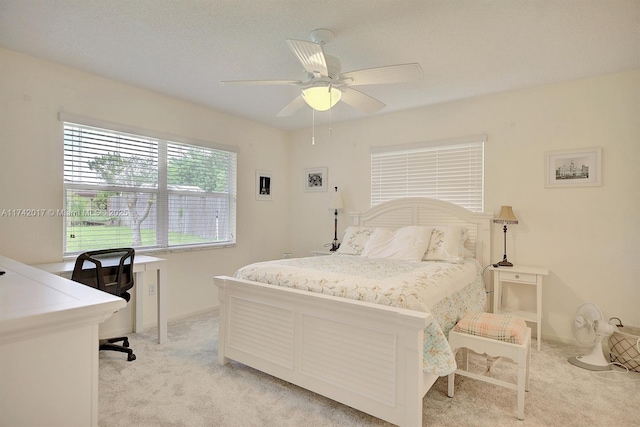 bedroom featuring light carpet and ceiling fan