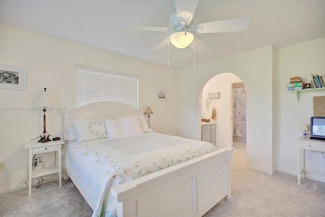 carpeted bedroom with ceiling fan and ensuite bathroom