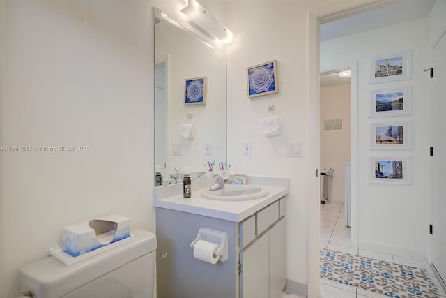 bathroom featuring vanity, tile patterned floors, and toilet