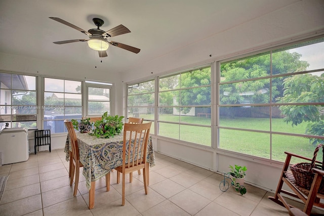 sunroom featuring ceiling fan