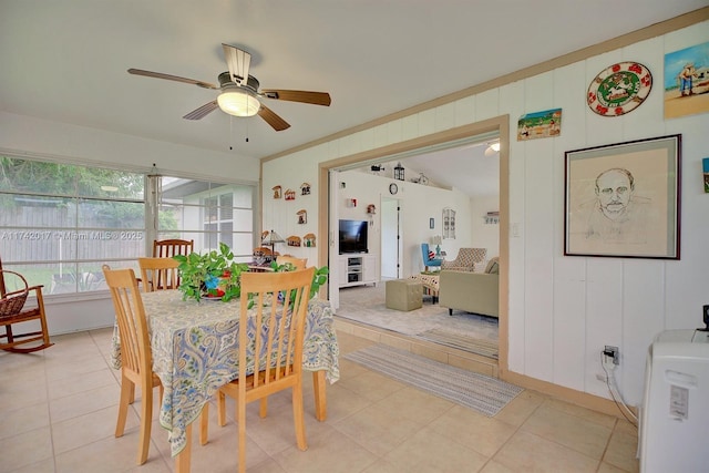 dining area featuring crown molding, light tile patterned floors, and ceiling fan