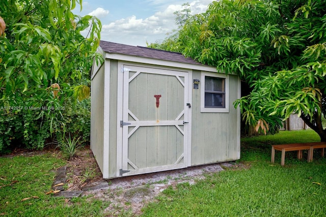 view of outbuilding featuring a lawn