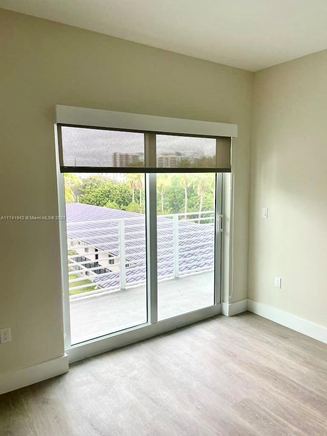 spare room with light hardwood / wood-style flooring