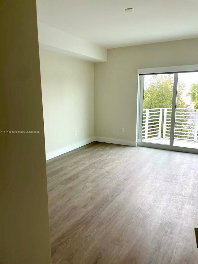 spare room featuring hardwood / wood-style floors