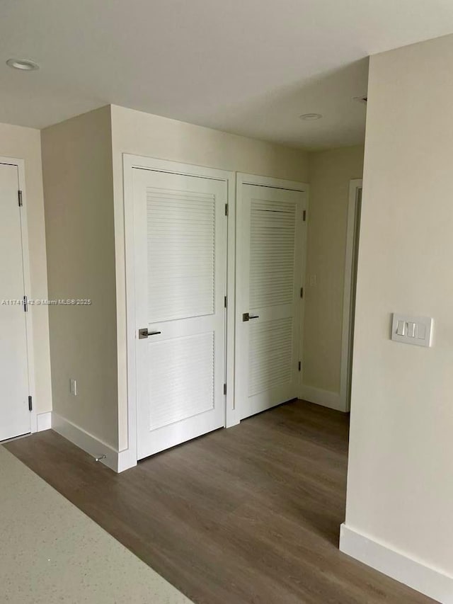 hallway featuring dark hardwood / wood-style flooring