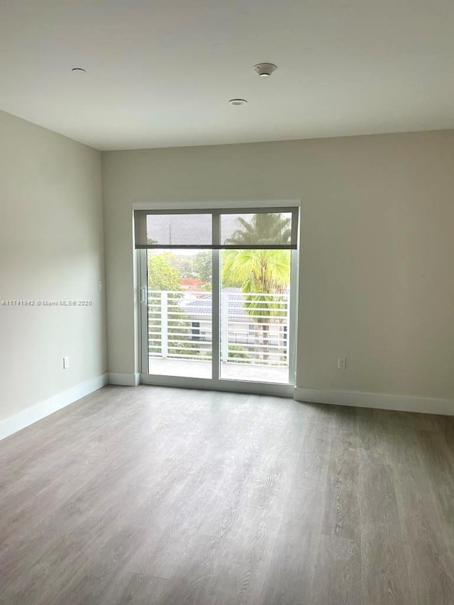 unfurnished room featuring hardwood / wood-style flooring