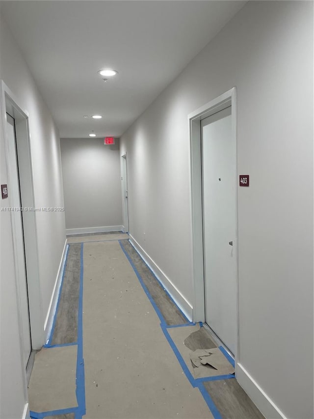 hall with concrete flooring