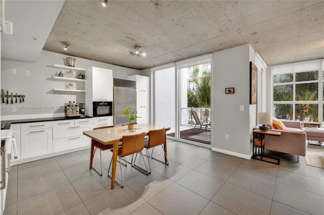 dining area with light tile patterned flooring and a healthy amount of sunlight