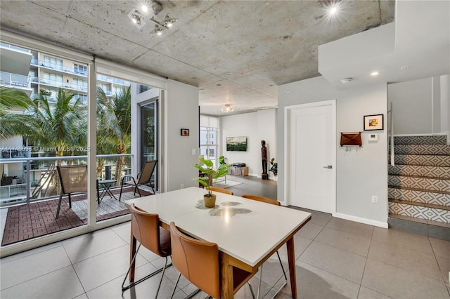 tiled dining area featuring expansive windows