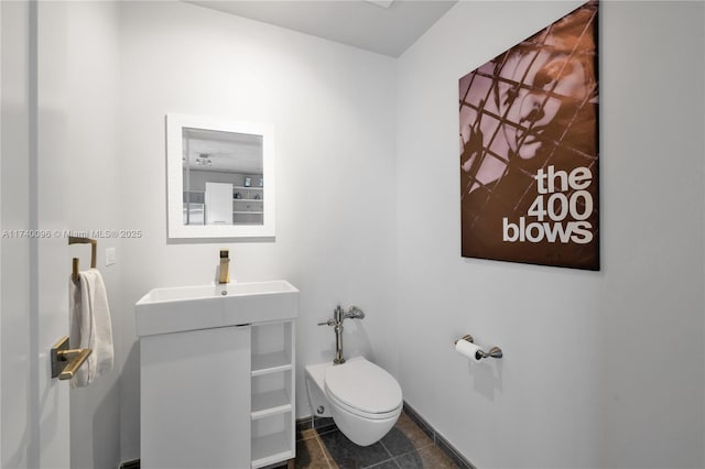 bathroom with vanity, tile patterned floors, and toilet