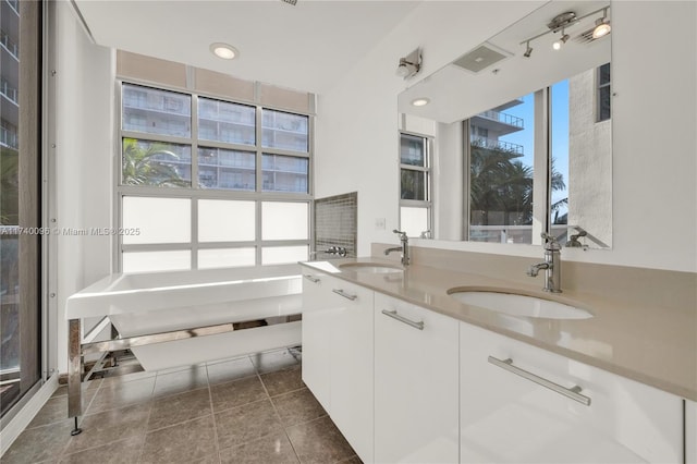 bathroom with vanity and tile patterned flooring