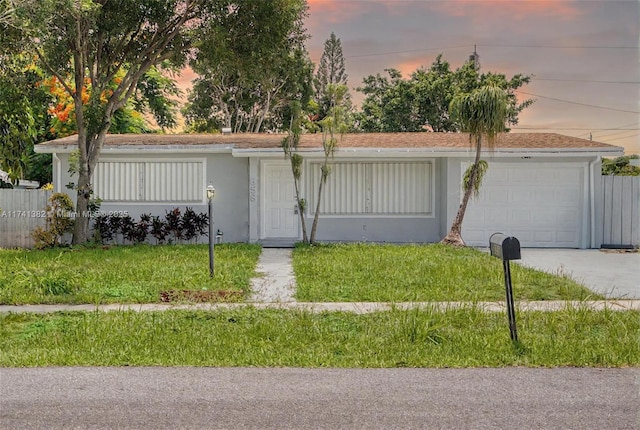 658 SW 1st Ct, Boynton Beach, FL 33426 - ranch-style home with an attached garage, a front yard, driveway, and stucco siding