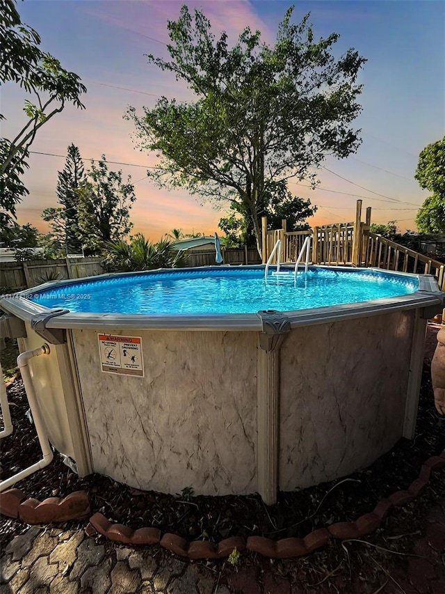 view of pool at dusk