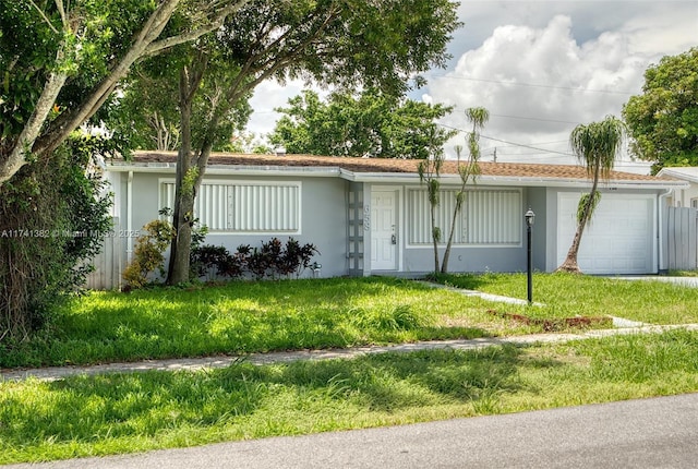658 SW 1st Ct, Boynton Beach, FL 33426 - ranch-style home with a garage, a front lawn, and stucco siding