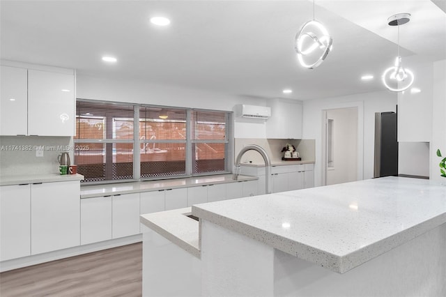 658 SW 1st Ct, Boynton Beach, FL 33426 - kitchen with modern cabinets, an AC wall unit, white cabinetry, and recessed lighting