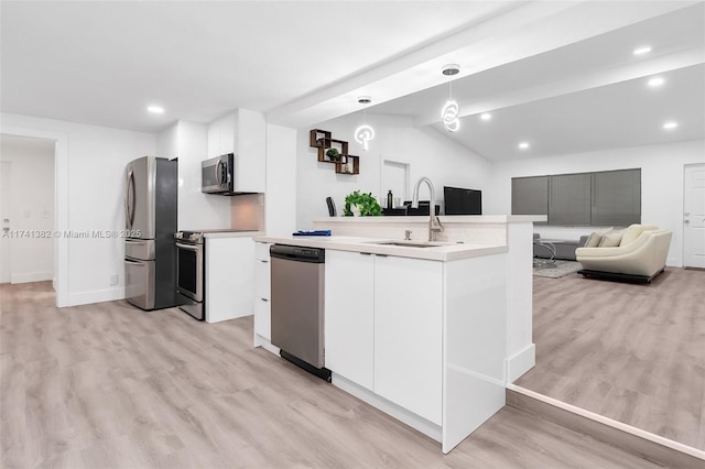 658 SW 1st Ct, Boynton Beach, FL 33426 - kitchen with stainless steel appliances, light wood-style flooring, recessed lighting, white cabinetry, and pendant lighting