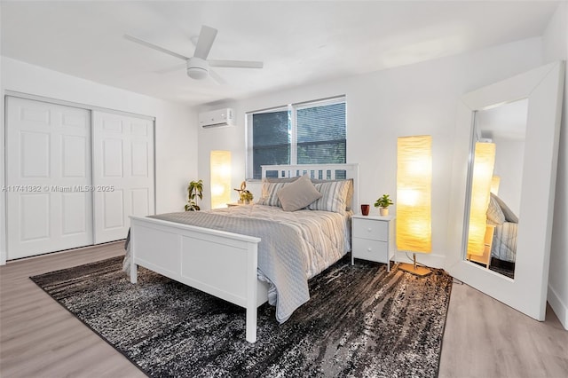 658 SW 1st Ct, Boynton Beach, FL 33426 - bedroom with a wall mounted air conditioner, wood finished floors, a ceiling fan, and a closet