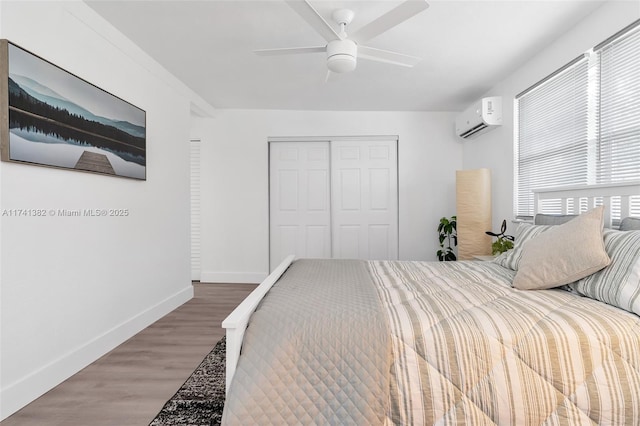 658 SW 1st Ct, Boynton Beach, FL 33426 - bedroom featuring a wall mounted AC, a closet, wood finished floors, and a ceiling fan