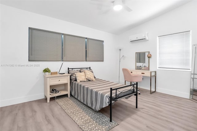 658 SW 1st Ct, Boynton Beach, FL 33426 - bedroom with a wall mounted AC, light wood-type flooring, vaulted ceiling, and ceiling fan