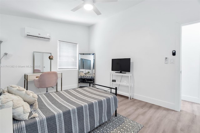 658 SW 1st Ct, Boynton Beach, FL 33426 - bedroom with a wall mounted air conditioner, light wood-style floors, and ceiling fan